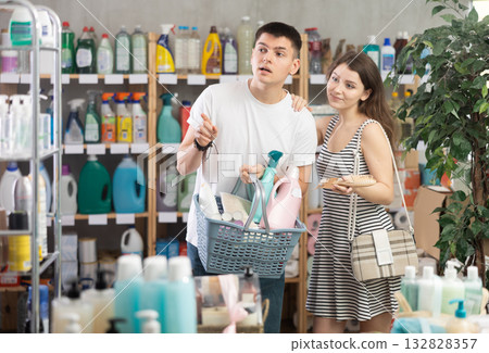 Couple chooses to shop in the household chemicals department Couple chooses to shop in the household chemicals department 132828357