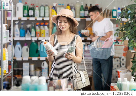 woman chooses sunscreen against the background of the buyer 132828362