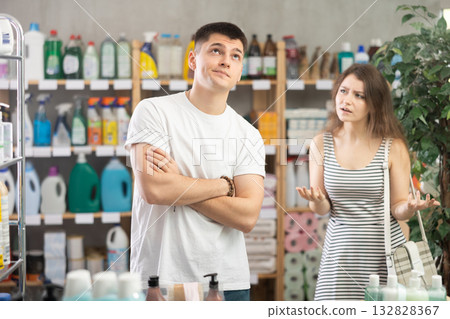 Girl yells at guy and reproaches him. Conflict during shopping, family disagreements 132828367