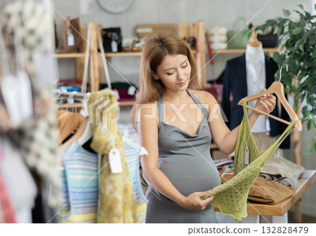 Pregnant woman choosing clothes 132828479