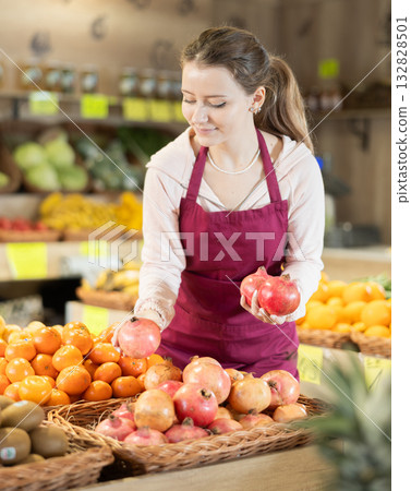 Young woman seller lays out grenades on the counter 132828501