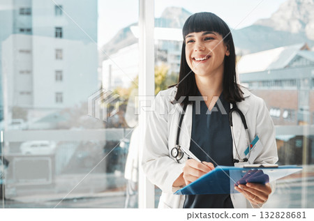 Woman, doctor and smile writing on clipboard by window for healthcare planning, strategy or notes. Happy female medical expert smiling with paperwork, prescription or medicare details at hospital Woman, doctor and smile writing on clipboard by window for healthcare planning, strategy or notes. Happy female medical expert smiling with paperwork, prescription or medicare details at hospital 132828681
