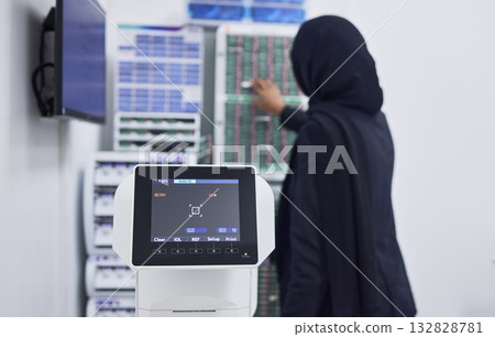 Optometry, screen for eye exam and Muslim optician with machine for vision test, eyesight and optical assessment. Healthcare, ophthalmology and optometrist working on medical camera for eyes scan 132828781