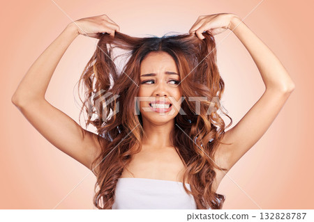Beauty, sad and hair loss of woman in studio isolated on a pink background for haircare. Hairstyle, face and frustrated female model with keratin problem, split ends and damage after salon treatment. Beauty, sad and hair loss of woman in studio isolated on a pink background for haircare. Hairstyle, face and frustrated female model with keratin problem, split ends and damage after salon treatment. 132828787