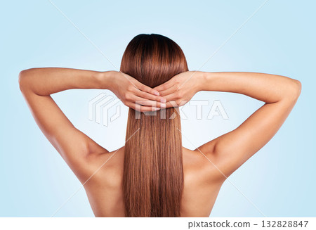 Back, hair care and beauty of woman in studio isolated on a blue background. Hairstyle, keratin cosmetics and aesthetics of young female model with salon treatment for growth, texture and balayage. 132828847
