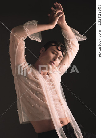 Gender neutral, portrait and gen z fashion with designer clothing and faux vintage pearls in studio. Isolated, black background and lgbtq or gay model with jewelry and creativity and non binary art 132828909
