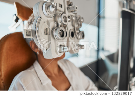 Healthcare test, eye exam and woman in optometry clinic for vision, eyesight and optical assessment. Glasses, optometrist consultation and patient with medical equipment, phoropter and lens for eyes 132829017