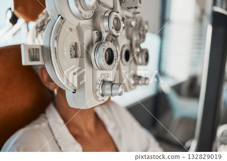 Ophthalmologist phoropter, patient consultation or eye exam for vision, healthcare or wellness. Senior woman, ophthalmology care and health for eyes in office, hospital or store for vision assessment 132829019