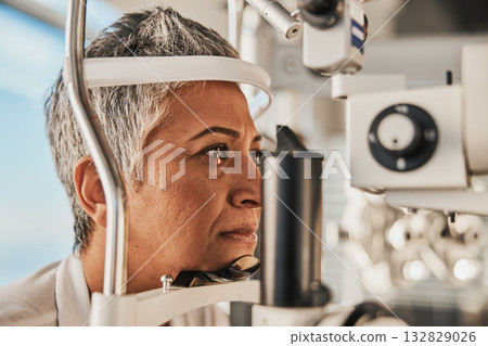 Optometry, slit lamp and eye exam by senior woman or patient with medical insurance using machine. Ophthalmology, eyesight and female test vision in clinic as eyecare during consultation Optometry, slit lamp and eye exam by senior woman or patient with medical insurance using machine. Ophthalmology, eyesight and female test vision in clinic as eyecare during consultation 132829026