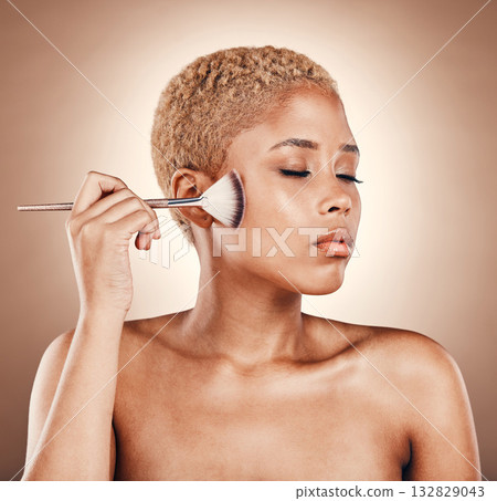 Makeup, brush and woman, face and beauty with cosmetic care, glow and cosmetology on studio background. Foundation, powder and cosmetics tools and product with hand, skincare with zen and eyes closed 132829043