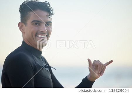 Shaka, portrait and man surfer at the beach for water sports training or exercise while on vacation. Happy, smile and male athlete with a hang loose hand sign ready for a surfing workout in Australia Shaka, portrait and man surfer at the beach for water sports training or exercise while on vacation. Happy, smile and male athlete with a hang loose hand sign ready for a surfing workout in Australia 132829094