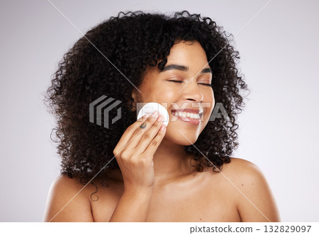 Beauty, cotton pad and face of black woman with smile for wellness, skincare routine and healthy glow. Dermatology, luxury spa and happy girl with swab to remove makeup, cosmetics and facial products Beauty, cotton pad and face of black woman with smile for wellness, skincare routine and healthy glow. Dermatology, luxury spa and happy girl with swab to remove makeup, cosmetics and facial products 132829097