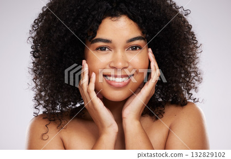 Portrait, beauty and afro with a model black woman in studio on a gray background for natural hair treatment. Face, skincare and haircare with an attractive young female posing to promote cosmetics 132829102