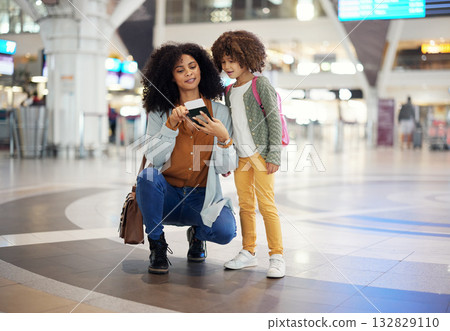 Travel, passport and mother with her child in the airport checking their boarding pass together. Trip, technology and woman browsing on a cellphone with girl kid while waiting for flight in terminal. Travel, passport and mother with her child in the airport checking their boarding pass together. Trip, technology and woman browsing on a cellphone with girl kid while waiting for flight in terminal. 132829110