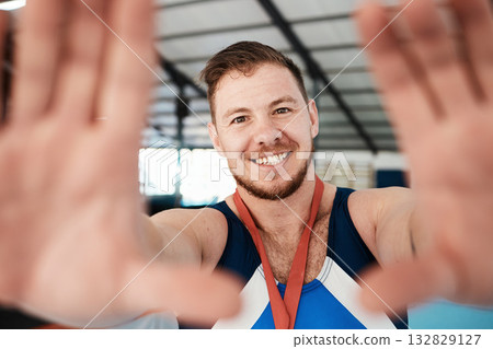 Gymnastics, sports and man athlete taking a selfie after winning a medal in a competition. Happy, smile and portrait of proud male gymnast winner taking a picture after training or practice in arena. Gymnastics, sports and man athlete taking a selfie after winning a medal in a competition. Happy, smile and portrait of proud male gymnast winner taking a picture after training or practice in arena. 132829127