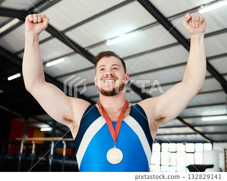 Man, medal celebration and winner with smile, indoor sports or hands in air at competition with pride. Champion athlete, happy and winning with gold, celebrate or success in global gymnastics contest Man, medal celebration and winner with smile, indoor sports or hands in air at competition with pride. Champion athlete, happy and winning with gold, celebrate or success in global gymnastics contest 132829141