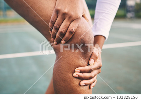 Knee injury, sport pain and netball athlete on a outdoor sports court with joint or muscle problem. Training, exercise and black woman hands holding legs with muscle and wellness issue from run 132829156