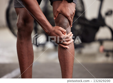 Knee pain, black man legs and gym fitness of a athlete with leg muscle and workout problem. Health, wellness and medical issue in a exercise studio holding joint and sports injury from training Knee pain, black man legs and gym fitness of a athlete with leg muscle and workout problem. Health, wellness and medical issue in a exercise studio holding joint and sports injury from training 132829200