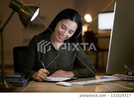 Happy, writing or business woman on notebook at night for creative idea, journal entry or proposal report. Smile, overtime or manager planning for company strategy or research notes on office desk Happy, writing or business woman on notebook at night for creative idea, journal entry or proposal report. Smile, overtime or manager planning for company strategy or research notes on office desk 132829317
