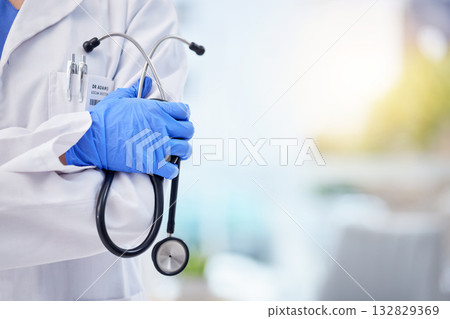 Doctor, hands and stethoscope with arms crossed on mockup for healthcare, life insurance or service. Hand of medical expert GP with latex gloves in cardiology for advice, help or medicare assurance 132829369