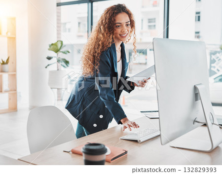 Businesswoman, computer and document in schedule tasks, planning or preparation strategy standing at office desk. Female employee manager checking desktop PC for project plan at the workplace Businesswoman, computer and document in schedule tasks, planning or preparation strategy standing at office desk. Female employee manager checking desktop PC for project plan at the workplace 132829393