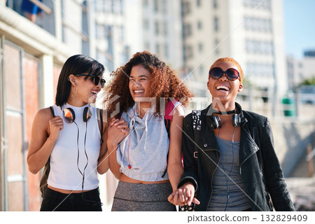 Women friends, holding hands and walk in city with smile, support or happiness for summer travel together. Black woman students, laughing and comic joke with excited face, happy and group vacation Women friends, holding hands and walk in city with smile, support or happiness for summer travel together. Black woman students, laughing and comic joke with excited face, happy and group vacation 132829409