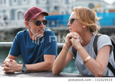 Man, woman and travel with happy conversation at harbor, vacation or date by ocean in summer sunshine. Senior couple, talk and listening with care, romantic bonding or love by sea for outdoor holiday Man, woman and travel with happy conversation at harbor, vacation or date by ocean in summer sunshine. Senior couple, talk and listening with care, romantic bonding or love by sea for outdoor holiday 132829419