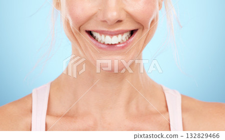 Smile, teeth whitening and woman mouth in studio, blue background and facial wellness. Closeup female model, clean dental and happy face of fresh breath, tooth implant and healthy aesthetic beauty Smile, teeth whitening and woman mouth in studio, blue background and facial wellness. Closeup female model, clean dental and happy face of fresh breath, tooth implant and healthy aesthetic beauty 132829466
