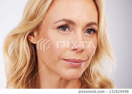 Beauty, face and a mature woman in studio for skincare, cosmetics and anti aging dermatology. Aesthetic model person on grey background for self love, care and healthy or wellness facial makeup glow Beauty, face and a mature woman in studio for skincare, cosmetics and anti aging dermatology. Aesthetic model person on grey background for self love, care and healthy or wellness facial makeup glow 132829496