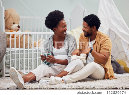 Funny, laundry and black couple getting ready for a baby, folding clothes and preparation in pregnancy. Happy, parents and pregnant woman and man sitting with clothing for child and conversation 132829674