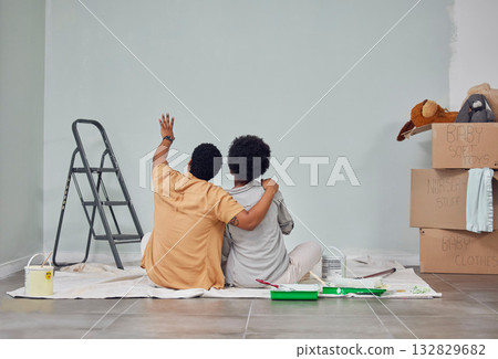 Planning, wall or black couple pointing in home renovation, diy or house remodel together on floor. Back view, painting or African man loves talking or working with teamwork in decoration with woman 132829682
