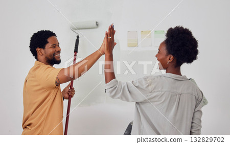 Painting, success or black couple high five in DIY, home renovation or house remodel together with a paintbrush. Happy smile, woman and fun African man with teamwork or support for decoration designs 132829702