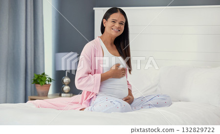 Pregnant woman, portrait and stomach in home bedroom happy about bonding and growth. Mother to be person with hands on abdomen for healthy pregnancy development, body wellness and love or care on bed Pregnant woman, portrait and stomach in home bedroom happy about bonding and growth. Mother to be person with hands on abdomen for healthy pregnancy development, body wellness and love or care on bed 132829722