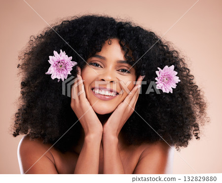 Face, portrait and black woman with flowers for hair care in studio isolated on a brown background. Floral cosmetics, hairstyle makeup and beauty of happy female model with plant for salon treatment. 132829880