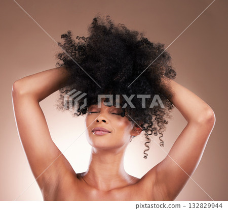 Natural hair, black woman with beauty and face, haircare and cosmetics with satisfaction on studio background. Female is content, arms and cosmetic care with curly hairstyle, texture and skincare Natural hair, black woman with beauty and face, haircare and cosmetics with satisfaction on studio background. Female is content, arms and cosmetic care with curly hairstyle, texture and skincare 132829944