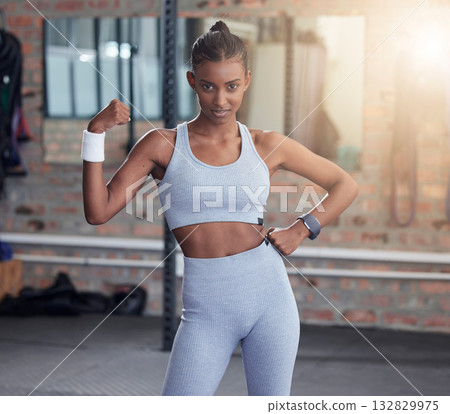Woman, fitness and portrait flexing bicep for empowerment, exercise or workout at the gym. Portrait of serious female in flex showing arm muscle, strength or power for healthy wellness at health club Woman, fitness and portrait flexing bicep for empowerment, exercise or workout at the gym. Portrait of serious female in flex showing arm muscle, strength or power for healthy wellness at health club 132829975