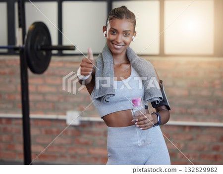 Woman, fitness and portrait smile with thumbs up for good job, workout success or thank you with water bottle at gym. Happy sporty female smiling showing thumb up emoji, yes sign or like for exercise 132829982