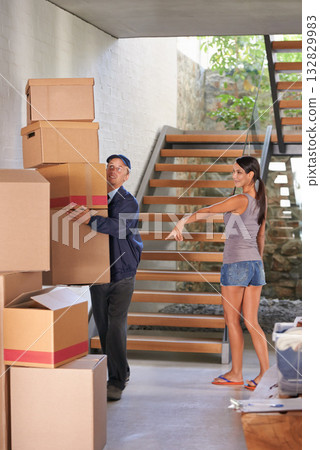 Smile, young woman and receiving delivery from postman for logistics at home or showing parcel for client. Freight, box and lady at her house for package or cargo from a courier and shipping company 132829983