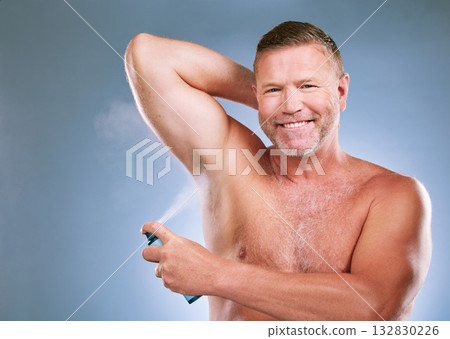 Man, armpit and deodorant in skincare hygiene, grooming or smelling fresh against a studio background. Portrait of elderly male smiling and spraying under arms for aroma or clean cosmetics on mockup 132830226