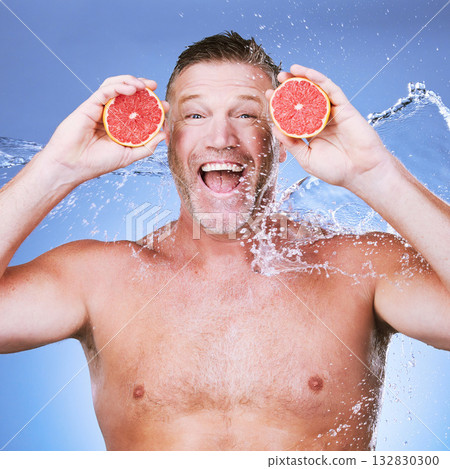 Excited man, grapefruit in hands and water in portrait, beauty skincare, eco friendly and vegan cosmetics on blue background. Hydration, vitamin c and hygiene, senior male smile and citrus fruit Excited man, grapefruit in hands and water in portrait, beauty skincare, eco friendly and vegan cosmetics on blue background. Hydration, vitamin c and hygiene, senior male smile and citrus fruit 132830300