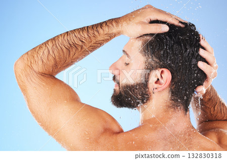 Man, shower and hair wash of a model in water for cleaning, skincare and hygiene wellness. Isolated, blue background and studio with a young person in bathroom for dermatology and self care routine Man, shower and hair wash of a model in water for cleaning, skincare and hygiene wellness. Isolated, blue background and studio with a young person in bathroom for dermatology and self care routine 132830318