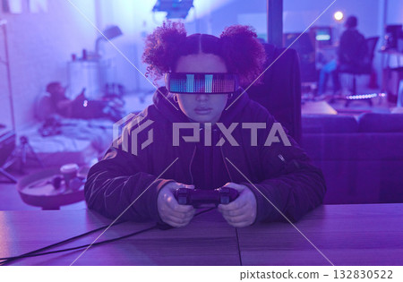 Virtual reality glasses, metaverse and woman gamer with controller for futuristic gaming in neon room. Person with ar tech for 3d, vr and cyber world experience streaming online digital fantasy game 132830522
