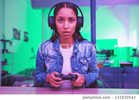 Gamer, headphones and portrait of woman in home at night in neon light for web esports. Gaming face, cyber technology and gen z female with controller playing online games and video game in house. 132830542