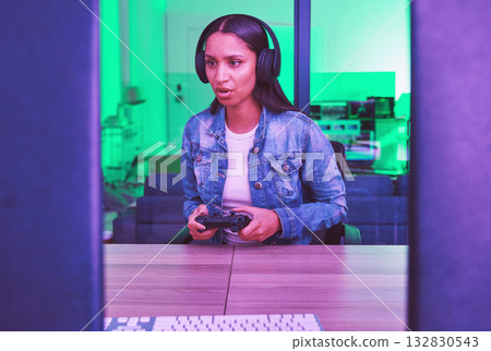 Headphones, gamer and woman on computer in home at night in green neon light for web esports. Gaming, technology and female with controller playing online games, multiplayer or video game in house. Headphones, gamer and woman on computer in home at night in green neon light for web esports. Gaming, technology and female with controller playing online games, multiplayer or video game in house. 132830543