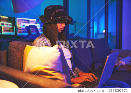 Woman, hacker and programmer typing on laptop in home at night in neon to hack software. Cybersecurity sofa, ransomware phishing and female coder coding on computer for hacking database with malware. Woman, hacker and programmer typing on laptop in home at night in neon to hack software. Cybersecurity sofa, ransomware phishing and female coder coding on computer for hacking database with malware. 132830571