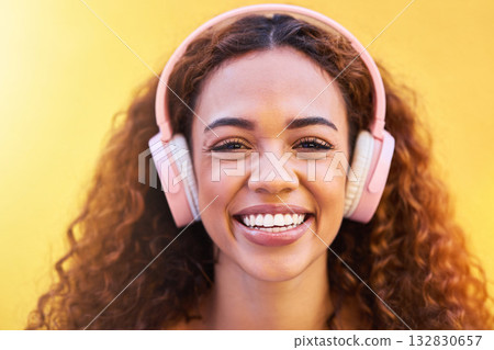 Music, portrait and smile with a black woman listening to the radio outdoor on a yellow wall background. Headphones, energy and face with an attractive young female streaming audio sound for fun Music, portrait and smile with a black woman listening to the radio outdoor on a yellow wall background. Headphones, energy and face with an attractive young female streaming audio sound for fun 132830657