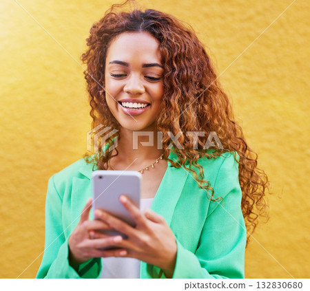 Phone, beauty and black woman isolated on wall background for networking, makeup blog or fashion color tips. Young model or person typing on mobile app or smartphone for sale, discount and cosmetics Phone, beauty and black woman isolated on wall background for networking, makeup blog or fashion color tips. Young model or person typing on mobile app or smartphone for sale, discount and cosmetics 132830680