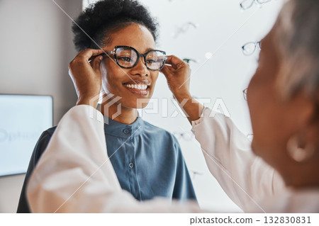 Glasses check, black woman and customer with store worker and optician looking at lense. Eye consulting, smile and eyewear assessment in a frame shop for vision test and prescription exam for eyes Glasses check, black woman and customer with store worker and optician looking at lense. Eye consulting, smile and eyewear assessment in a frame shop for vision test and prescription exam for eyes 132830831