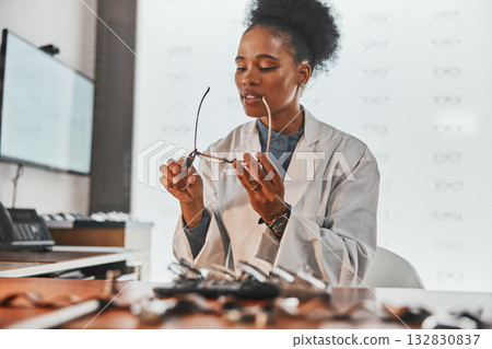 Optometry, repair and optometrist fixing glasses for prescription frame in the optic clinic. Healthcare, vision and African female optician doing maintenance on eyewear or spectacles in optical store Optometry, repair and optometrist fixing glasses for prescription frame in the optic clinic. Healthcare, vision and African female optician doing maintenance on eyewear or spectacles in optical store 132830837