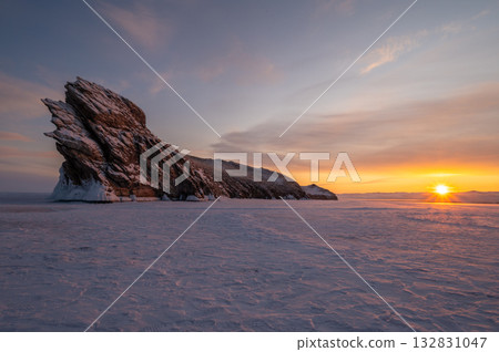 Scenery view of the Dragon tail rock at sunrise. It's located at Ogoy island in frozen lake Baikal, Russia. Scenery view of the Dragon tail rock at sunrise. It's located at Ogoy island in frozen lake Baikal, Russia. 132831047